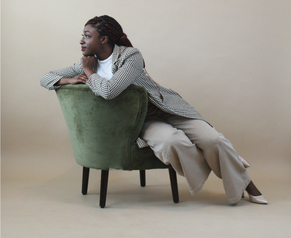 Damisi seated in a green chair