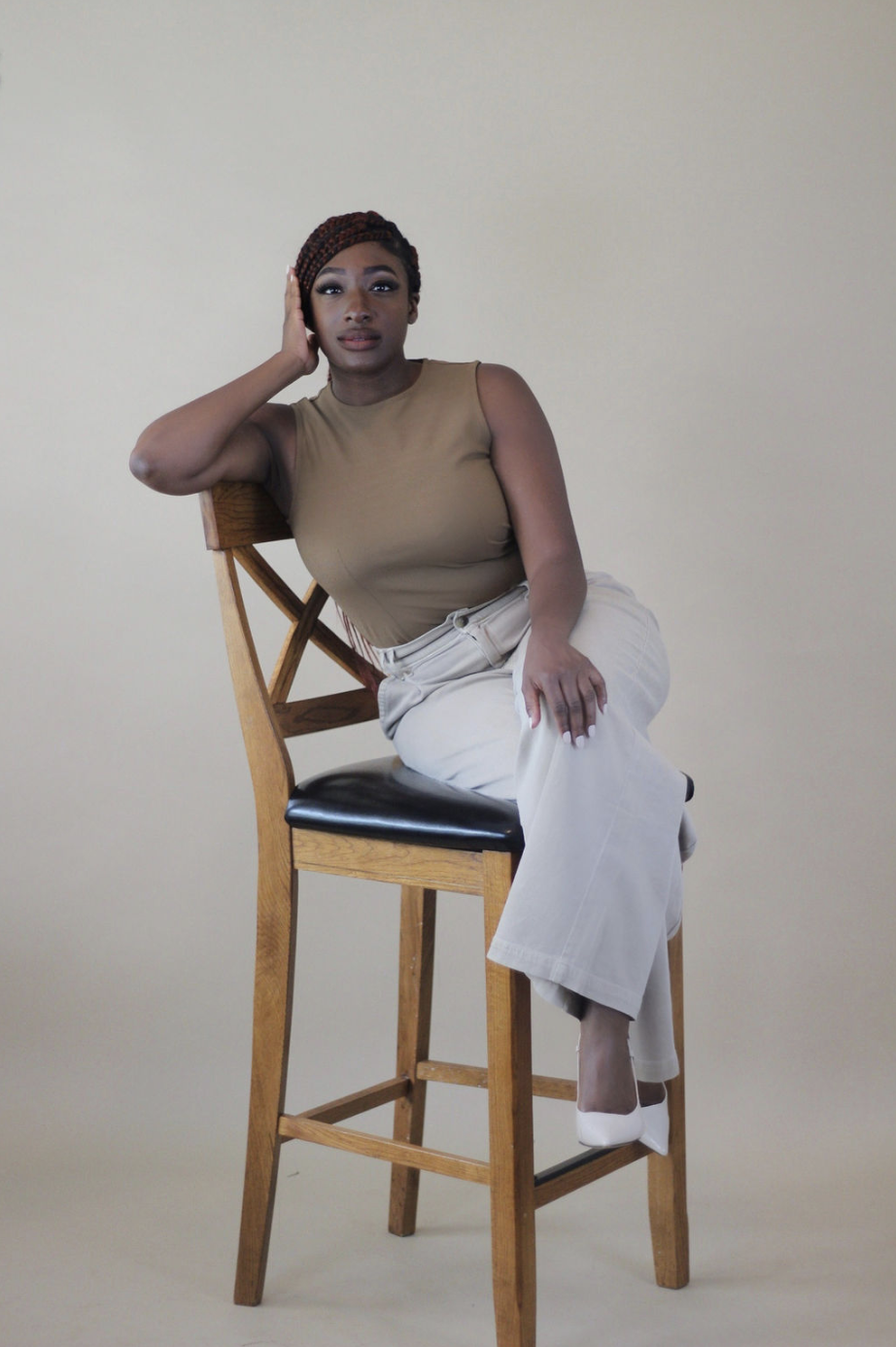 Damisi seated on a wooden chair